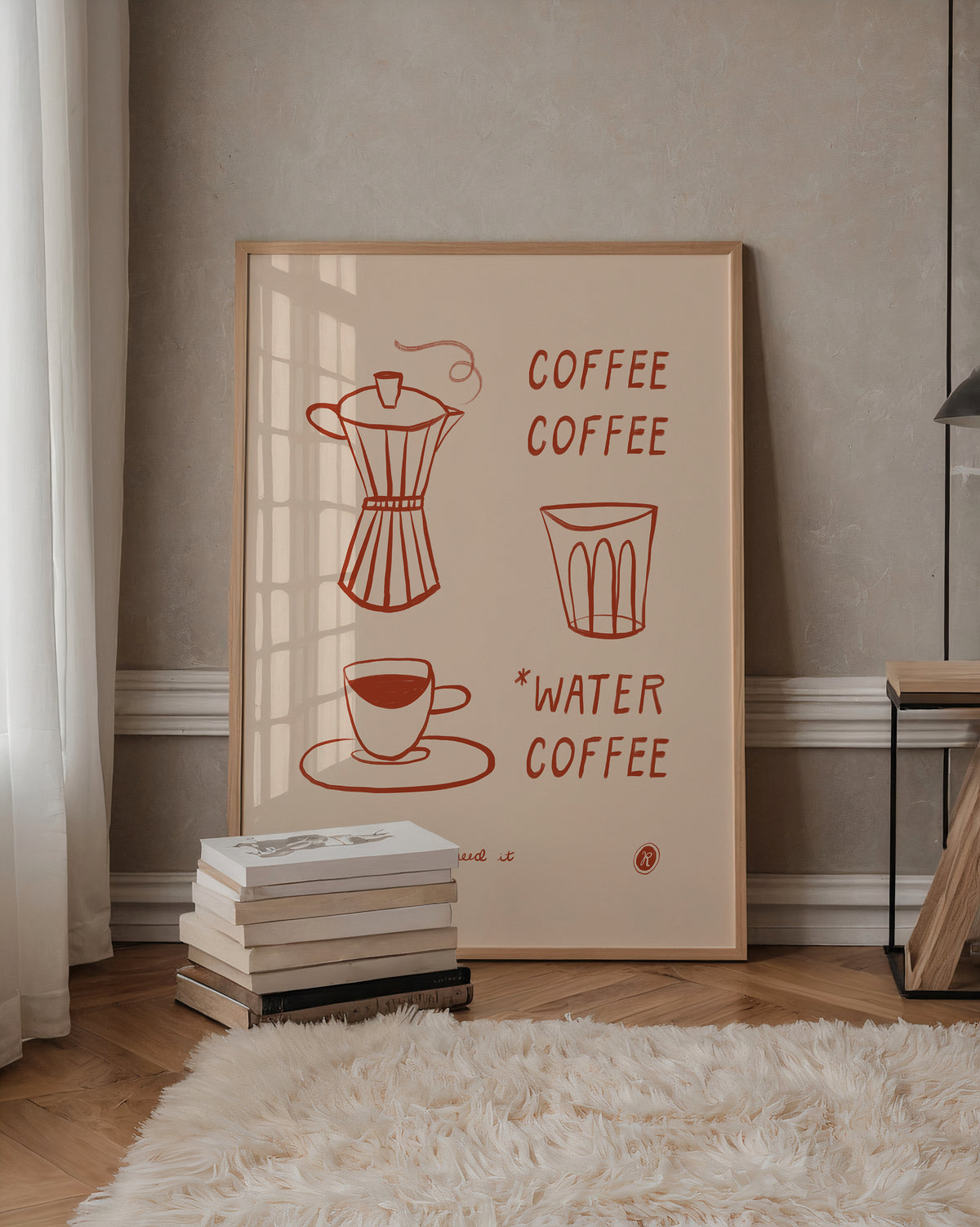 A framed minimalist coffee-themed art print leaning against a beige wall in a styled room. The print features red line drawings of a moka pot, a glass, a cup, and the words 'COFFEE' and '*WATER COFFEE' on a cream background.